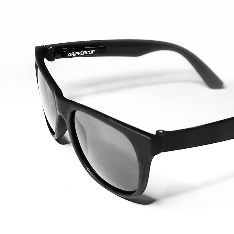 GripperClip shown installed on a pair of black sunglasses.